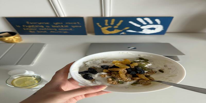 A hand holding a plate of food AI-generated content may be incorrect.